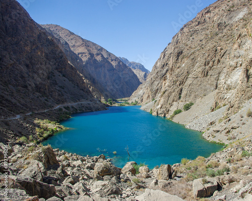 Turquoise blue Gushor lake in scenic mountain landscape in the Marguzor seven lakes area, Shing river valley, Fann mountains, near Penjikent or Panjakent in Tajikistan