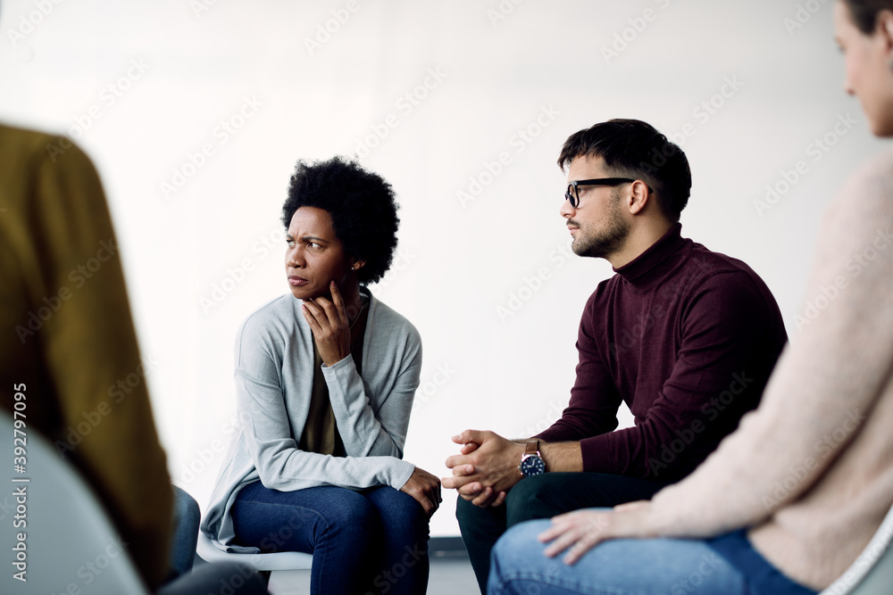 Group of people attending therapy meeting at mental health center. Group of people attending therapy meeting at mental health center.
