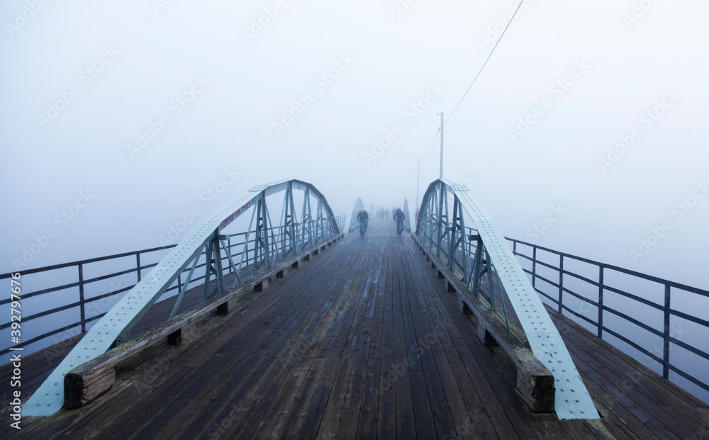 Umea, Norrland Sweden - September 27, 2019: bridge in fog with cyclists