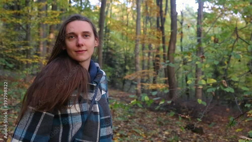 Long haired young woman with no makeup smiling on nature background Long haired young woman with no makeup smiling on nature background
