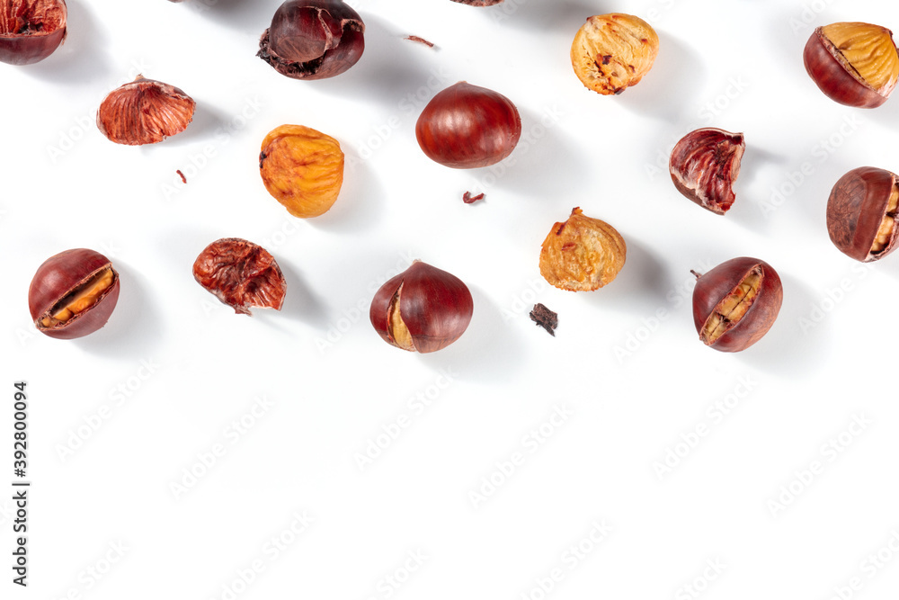 Roasted chestnuts background with a place for text, overhead flat lay shot on a white background Roasted chestnuts background with a place for text, overhead flat lay shot on a white background