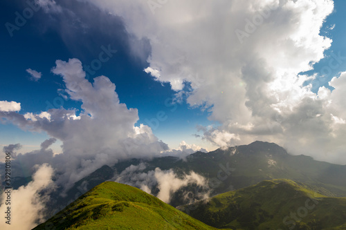 Beautiful mountain landscape at Caucasus mountains with clouds and blue sky