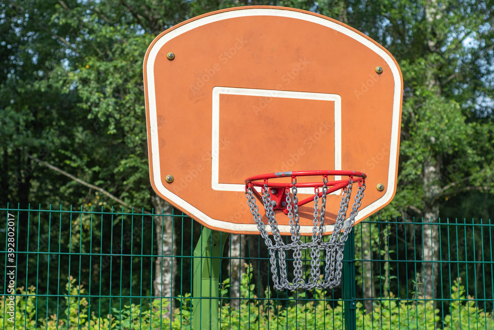Close-up of a street basketball hoop in a park with steel wire mesh Close-up of a street basketball hoop in a park with steel wire mesh