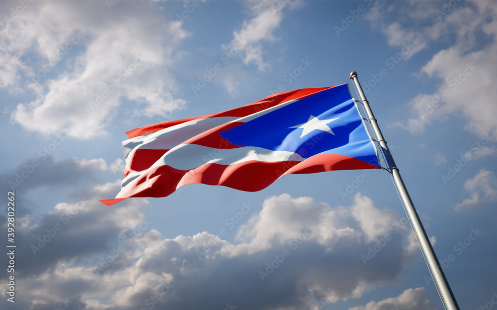 Puerto Rico national flag waving at sky background close-up.