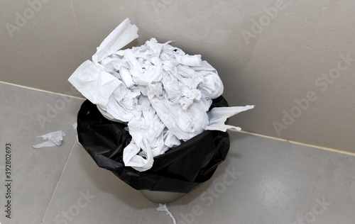 Toilet paper is thrown in the trash