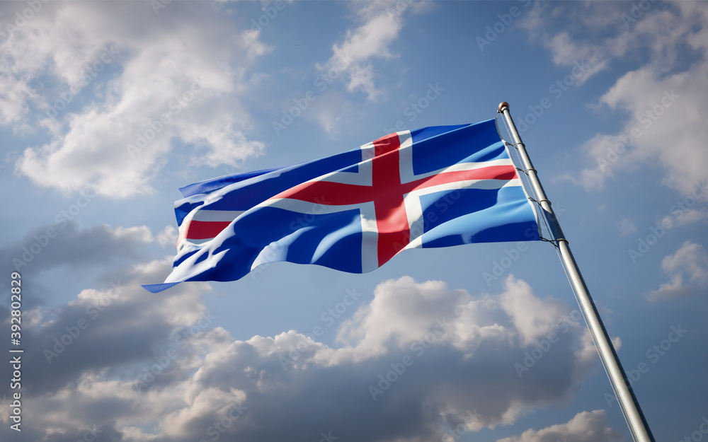 Iceland national flag waving at sky background close-up.