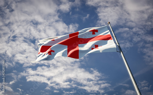 Georgia national flag waving at sky background close-up.