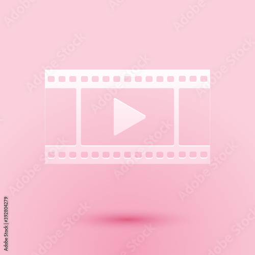 Paper cut Play Video icon isolated on pink background. Film strip with play sign. Paper art style. Vector.