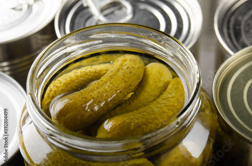 Canned pickles in just opened glass mason jar. Non-perishable food photo