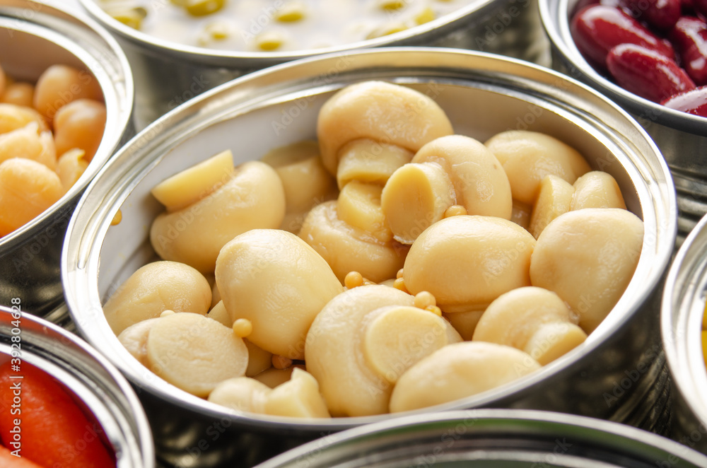 Canned button mushrooms in just opened tin can. Non-perishable food Canned button mushrooms in just opened tin can. Non-perishable food