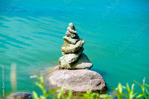 A stone sculpture stands in seawater 