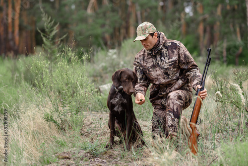 Hunting Dog Taking Smell Man with Rifle in Forest.