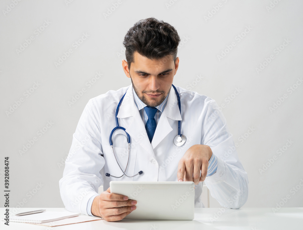 Young arab internist using tablet computer Young arab internist using tablet computer