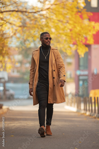 Stylish African American man walking in the autumn city © antgor