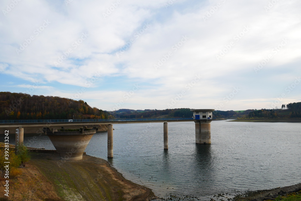 empty reservoir in autumn with bridge and tower