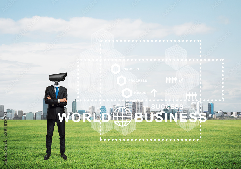 Camera headed man standing on green grass against modern cityscape Camera headed man standing on green grass against modern cityscape