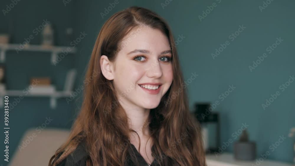 Portrait of Beautiful Young Caucasian Woman Looking Up to the Camera and Smiling Charmingly. Successful female business woman smiling happy entrepreneur enjoying successful startup company manager Portrait of Beautiful Young Caucasian Woman Looking Up to the Camera and Smiling Charmingly. Successful female business woman smiling happy entrepreneur enjoying successful startup company manager