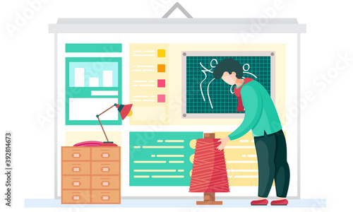 Sewing with designer or seamstress working with red skein of thread. Professional tailoring studio. Man working on creating of designer clothes. Creative environment for a man seamstress in work area