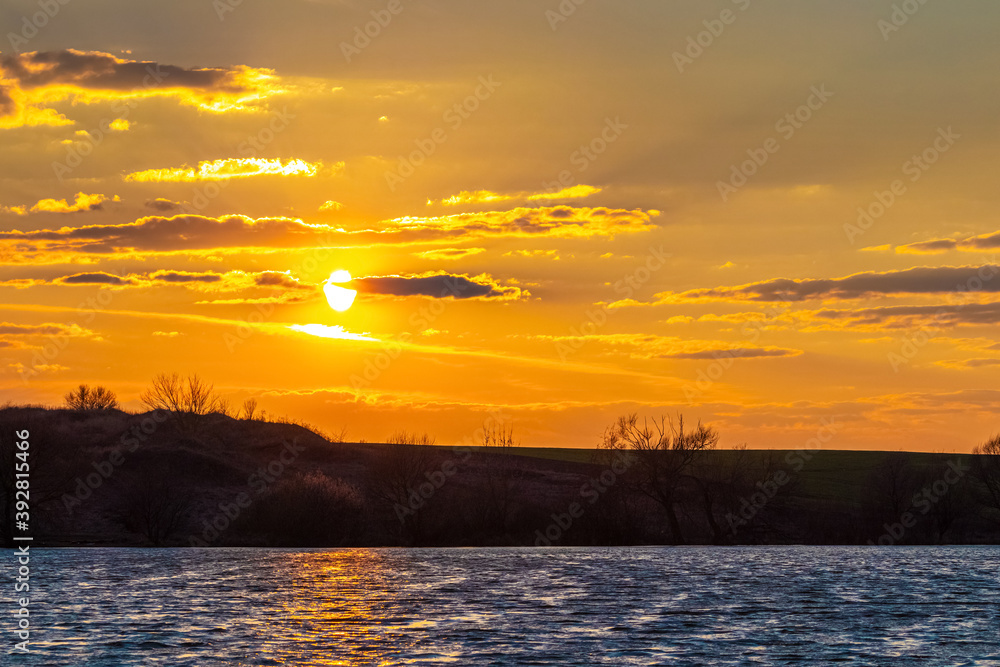Picturesque sky with clouds over the river during sunset