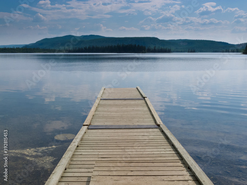 Wooden dock on a beautiful calm Yukon lake Canada