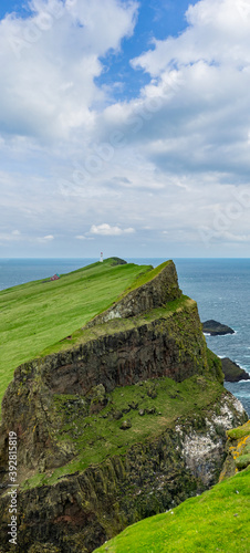 Lighthouse at the end of Mykines island in Faroe Islands
