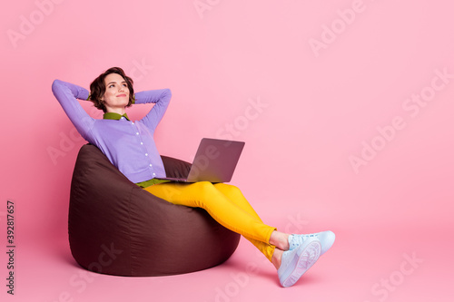 Full size profile side photo of calm girl sit bean chair work laptop relax wear pants shirt isolated pastel color background