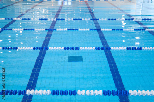 fragment of the competition pool with blue water and marked swimming lanes
