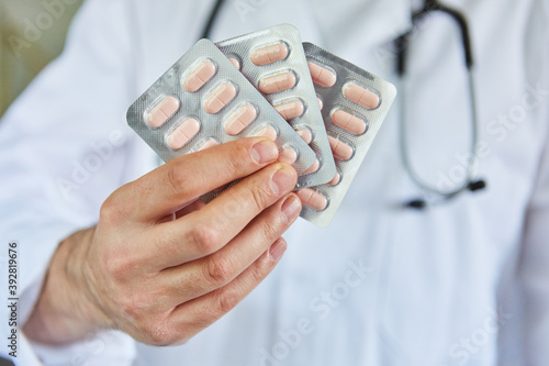 Hand of doctor in a clinic holding tablets