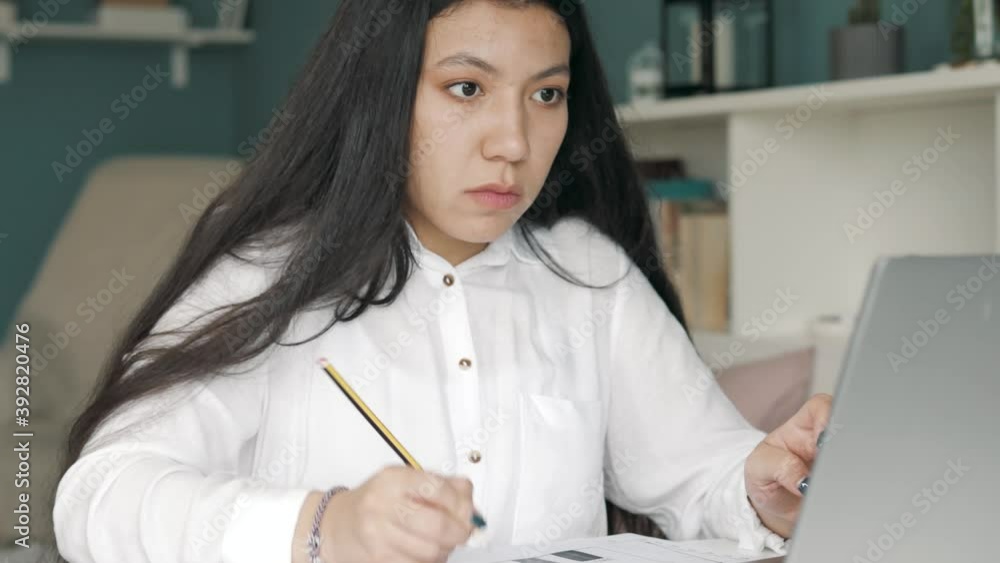 Asia freelance business women casual wear using tablet laptop computer in workplace in living room at home. Happy young hispanic girl relax sitting on desk do job in internet or study online from home Asia freelance business women casual wear using tablet laptop computer in workplace in living room at home. Happy young hispanic girl relax sitting on desk do job in internet or study online from home