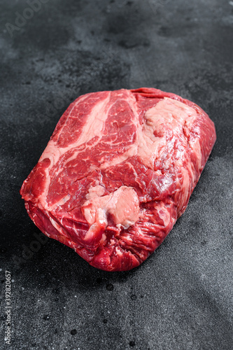 Raw Chuck eye roll steak. Organic beef. Black background. Top view