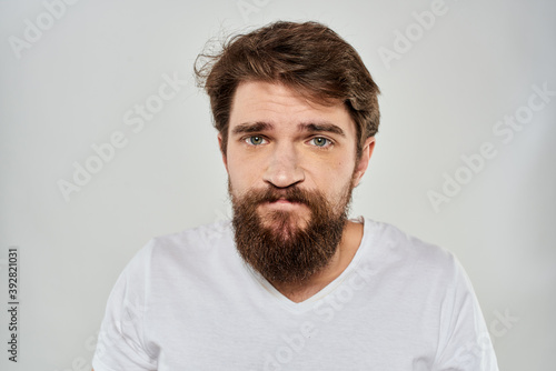 Bearded man gesturing with hand white cropped t-shirt studio lifestyle