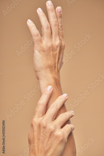 Photo of beautiful female hands on a beige background