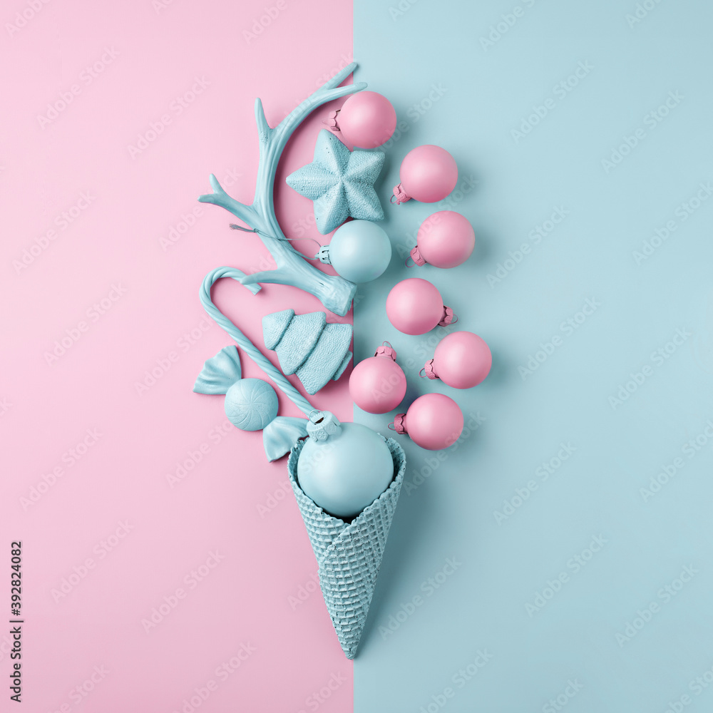 Creative Christmas layout made with ice cream cone and bauble ornaments on dual tone baby blue and pink pastel background. Minimal winter or New Year seasonal concept. Flat lay, top view. Creative Christmas layout made with ice cream cone and bauble ornaments on dual tone baby blue and pink pastel background. Minimal winter or New Year seasonal concept. Flat lay, top view.