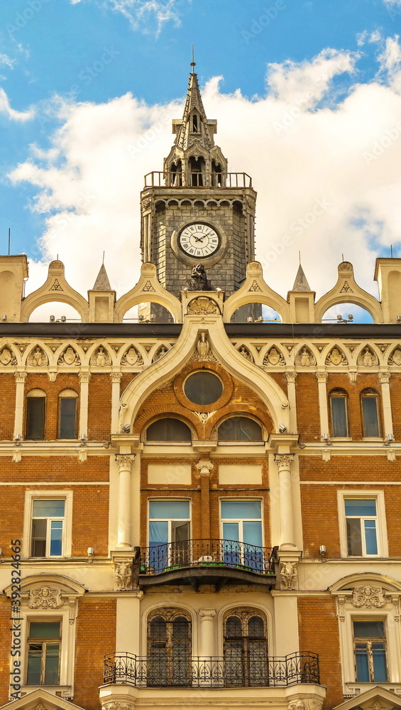 Moscow house in pseudo-gothic style, decorated with clock tower and stucco Moscow house in pseudo-gothic style, decorated with clock tower and stucco