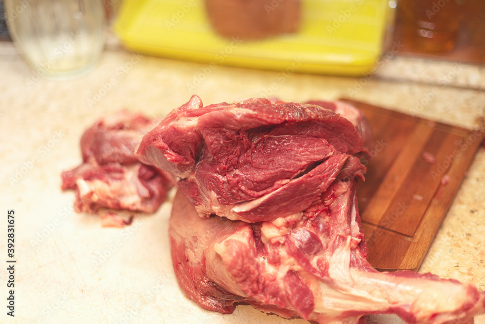 Obraz premium piece of fresh meat leg of pork cut at home in kitchen