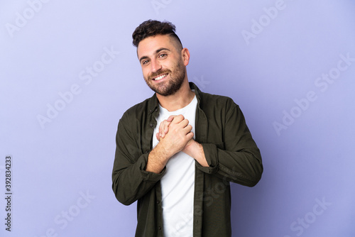 Caucasian man isolated on purple background laughing © luismolinero