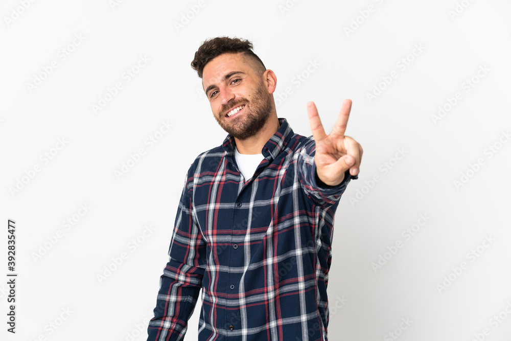 Caucasian man isolated on white background smiling and showing victory sign Caucasian man isolated on white background smiling and showing victory sign