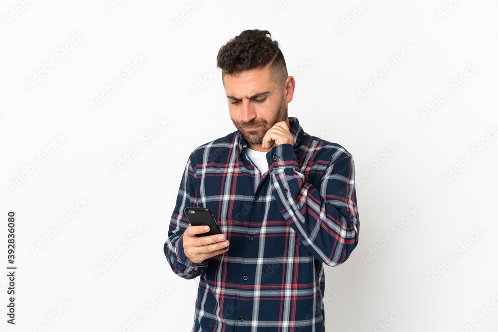 Caucasian man isolated on white background thinking and sending a message Caucasian man isolated on white background thinking and sending a message