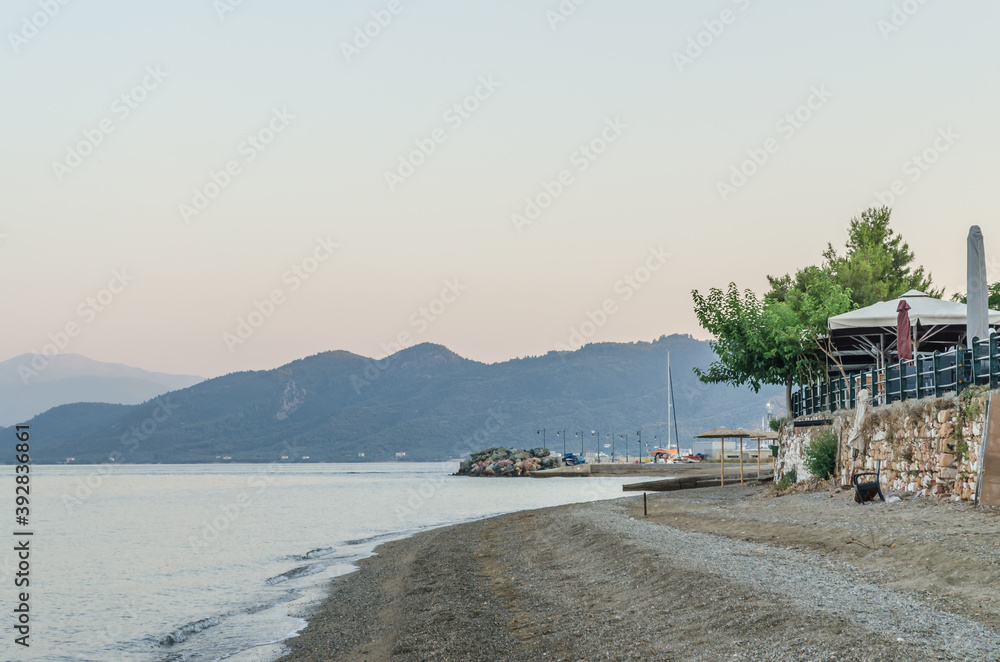 Evia island, Greece - June 28. 2020: Sandy beach in the morning on the island of Evia, Greece Evia island, Greece - June 28. 2020: Sandy beach in the morning on the island of Evia, Greece
