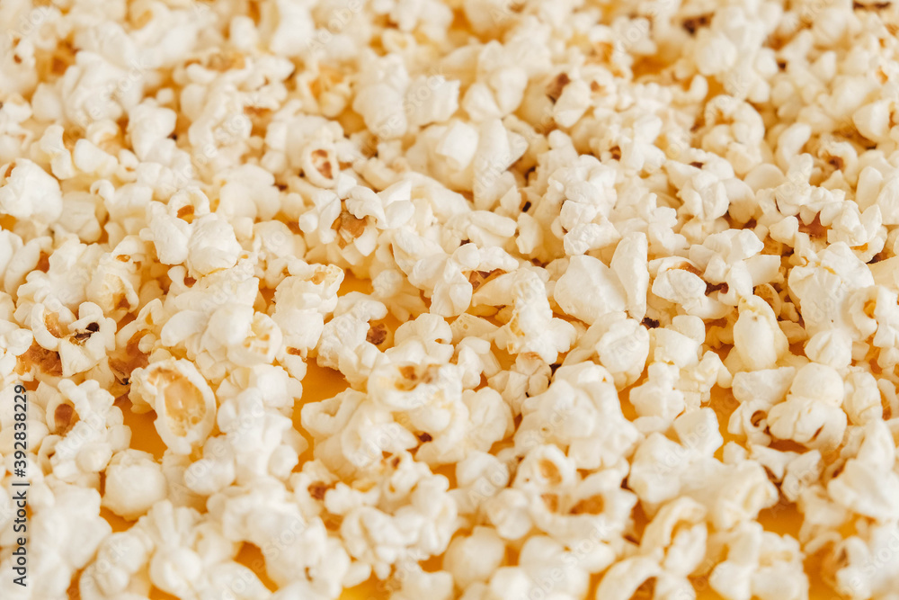 Popcorn on a yellow background as a background image. Top view. Copy, empty space for text Popcorn on a yellow background as a background image. Top view. Copy, empty space for text