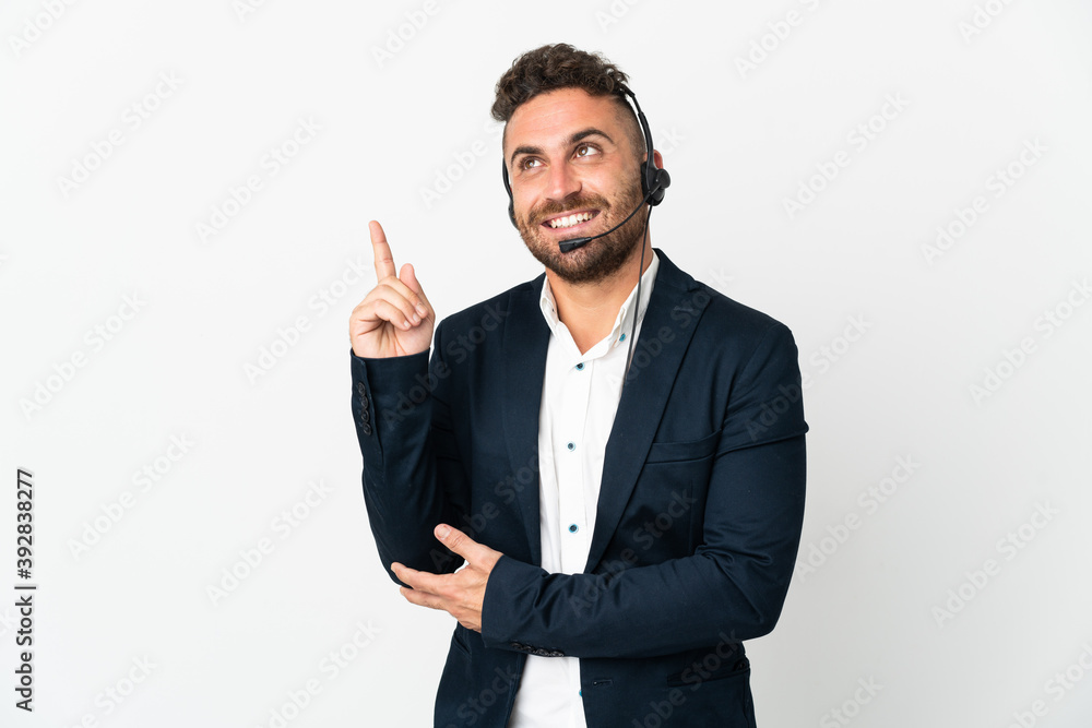 Telemarketer man working with a headset isolated on white background pointing up a great idea Telemarketer man working with a headset isolated on white background pointing up a great idea