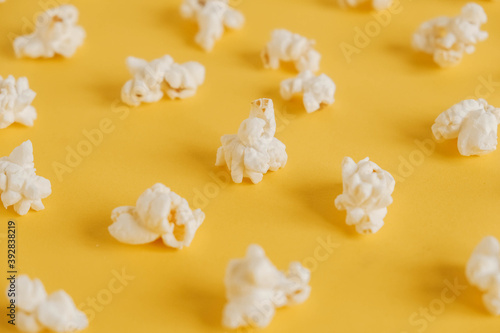 Popcorn on a yellow background as a background image. Top view. Copy, empty space for text © Andriy