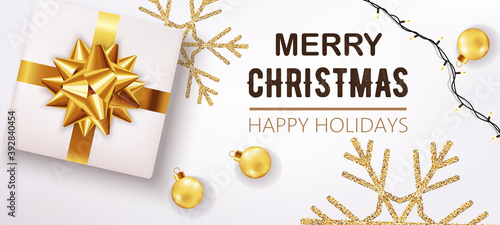 White christmas box with ribbon and golden decorations and festive lights in ...