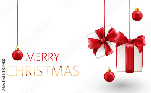 Christmas composition of hanging gift box with red ribbons and decorative bal...