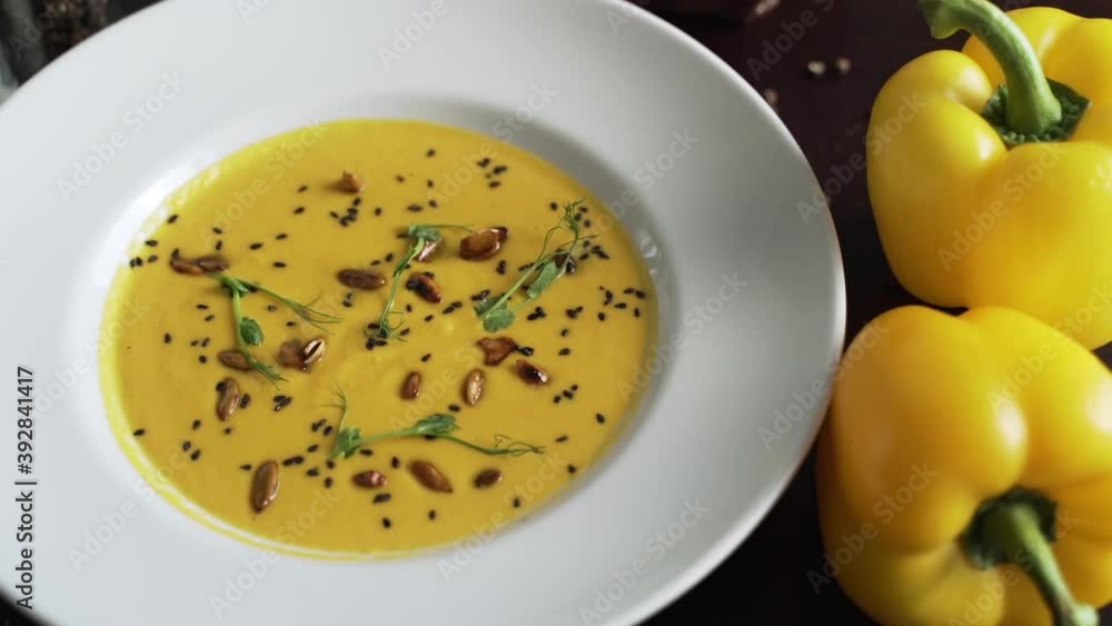 Yellow vegetable pureed soup in a white plate Yellow vegetable pureed soup in a white plate