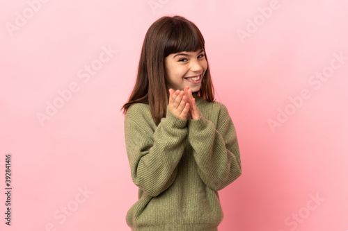 Little girl isolated on pink background applauding after presentation in a conference © luismolinero