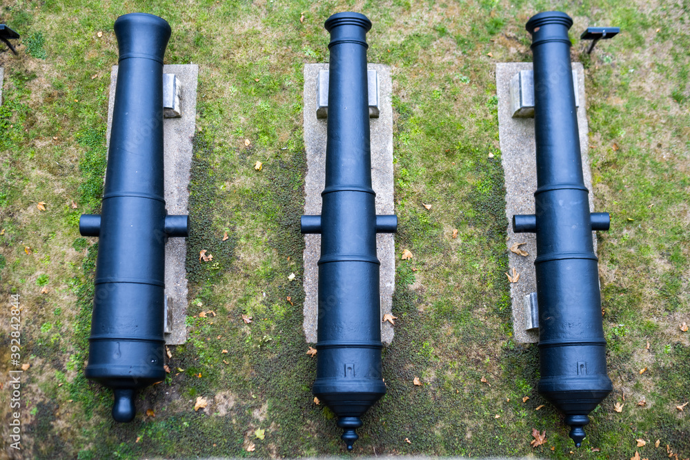 Top down image of three cannons in a row outside the Tower of London, UK Top down image of three cannons in a row outside the Tower of London, UK