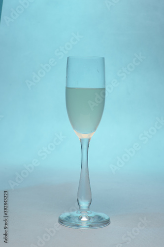 glas with white wine on blue backround