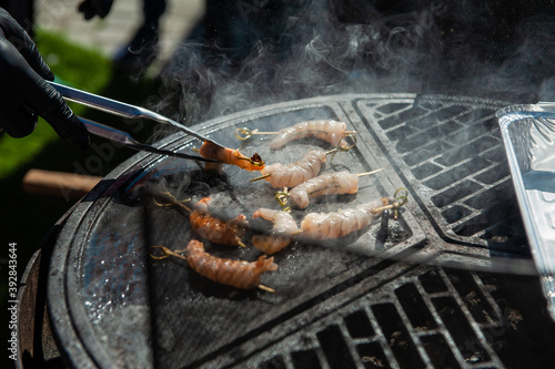 Wallpaper Mural A professional cook prepares shrimps on the grill outdoor, food or catering concept Torontodigital.ca