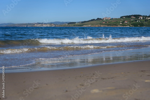 Sunny scenery of a sandy beach in the Oyambre natural park in San Vicente de la Barque